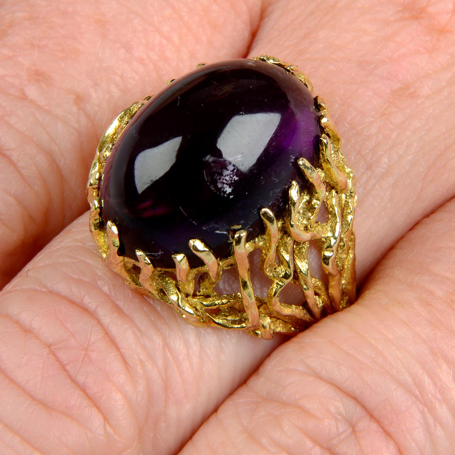 A 1970s 9ct gold amethyst cabochon textured abstract dress ring.