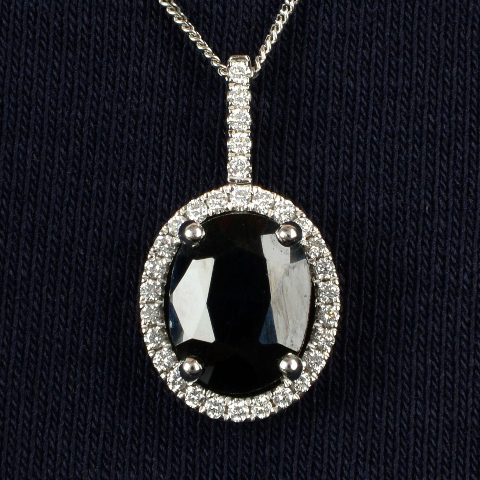 An 18ct gold sapphire and diamond cluster pendant, with chain.Sapphire weight 2.50cts.