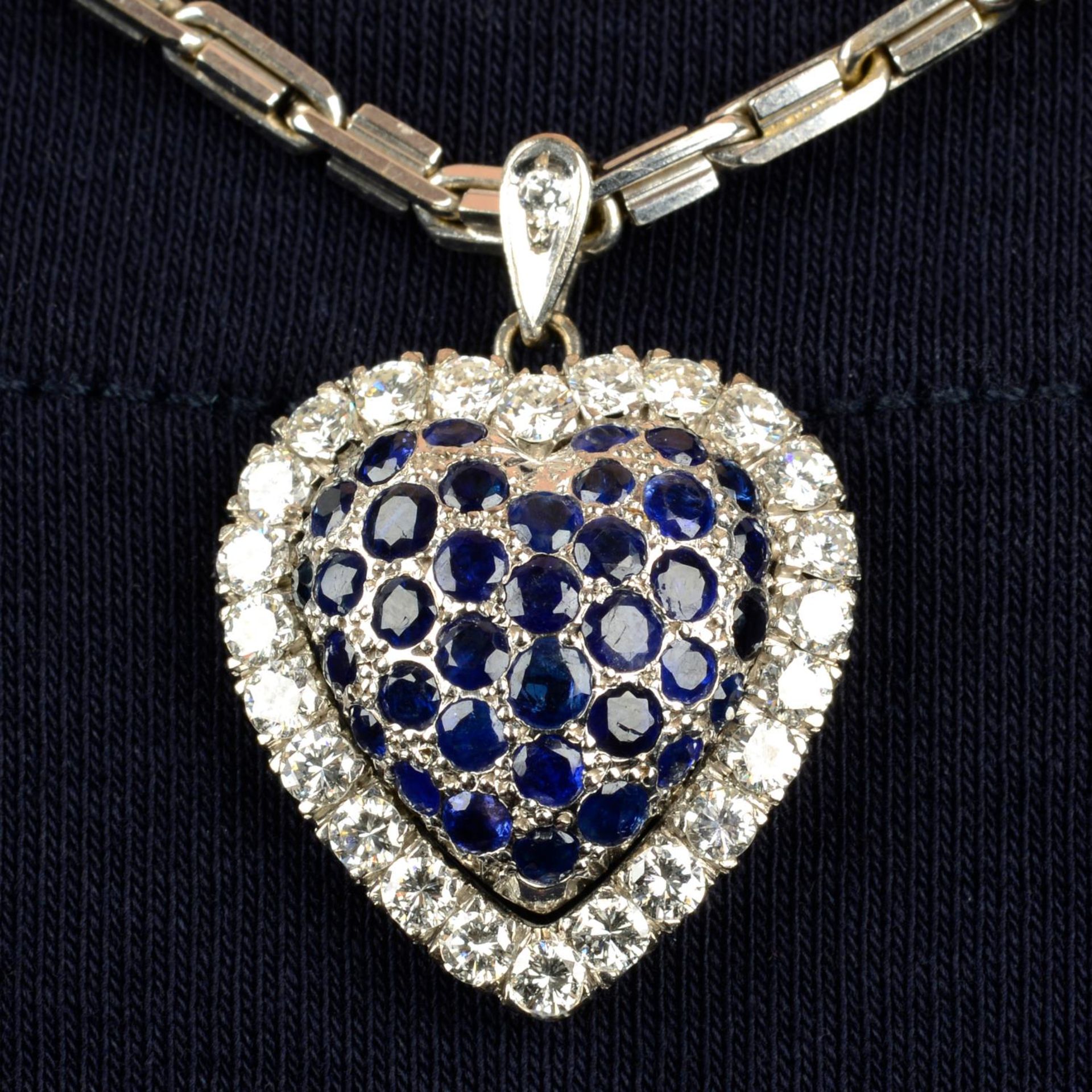 A sapphire and diamond heart-shape pendant, with chain.