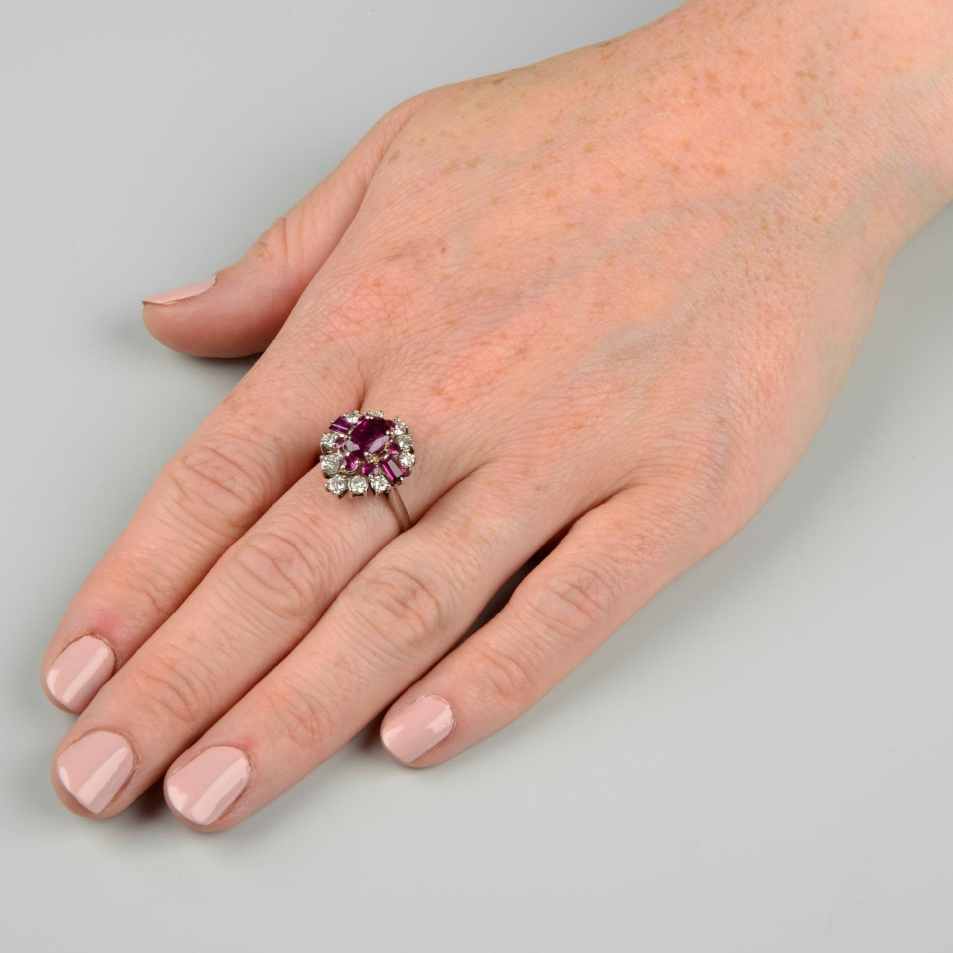 A vari-cut ruby and brilliant-cut diamond dress ring.Principal ruby calculated weight 1.23cts, - Image 3 of 6