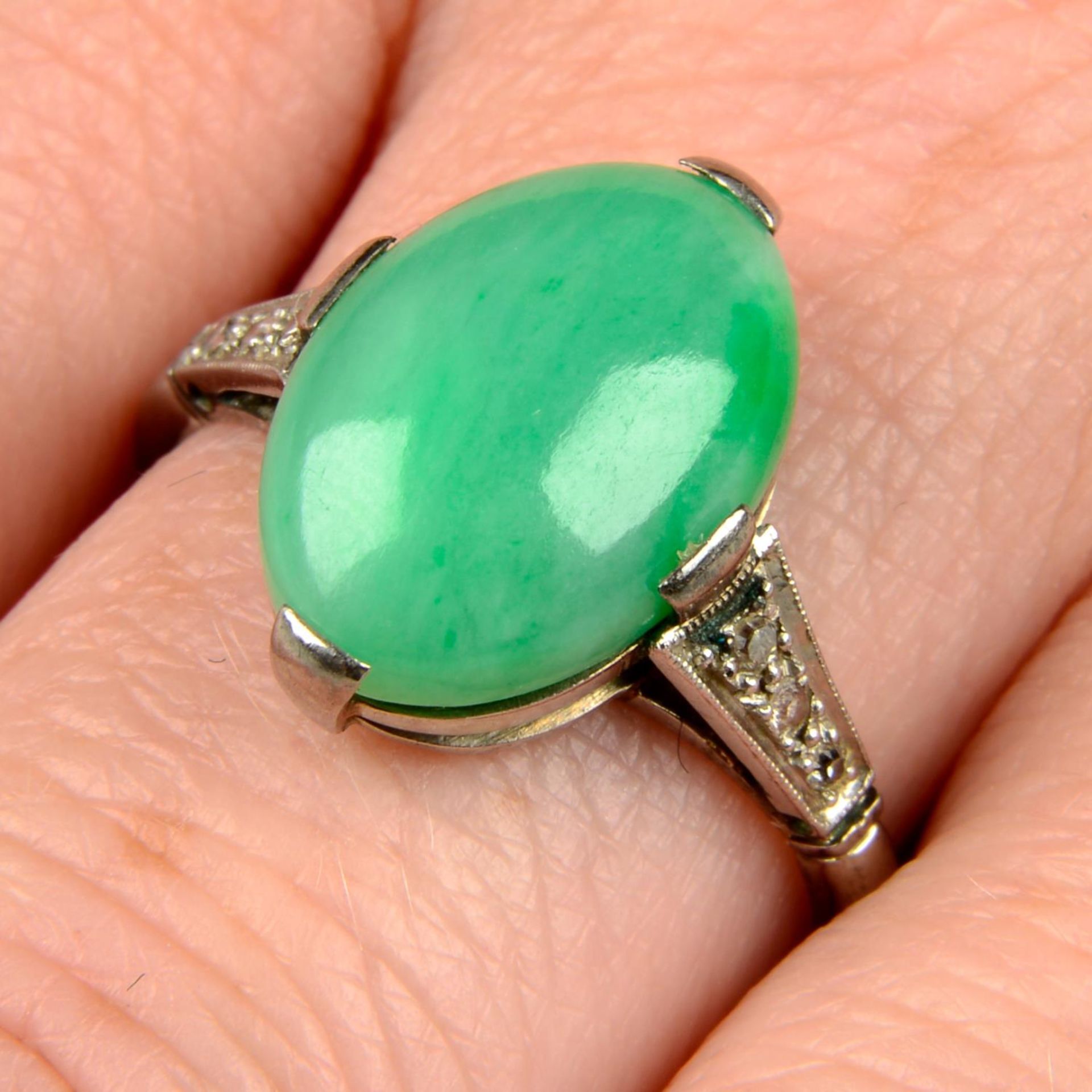 An Art Deco platinum and 18ct gold A-type jade cabochon and diamond ring.Verbal from GCS,