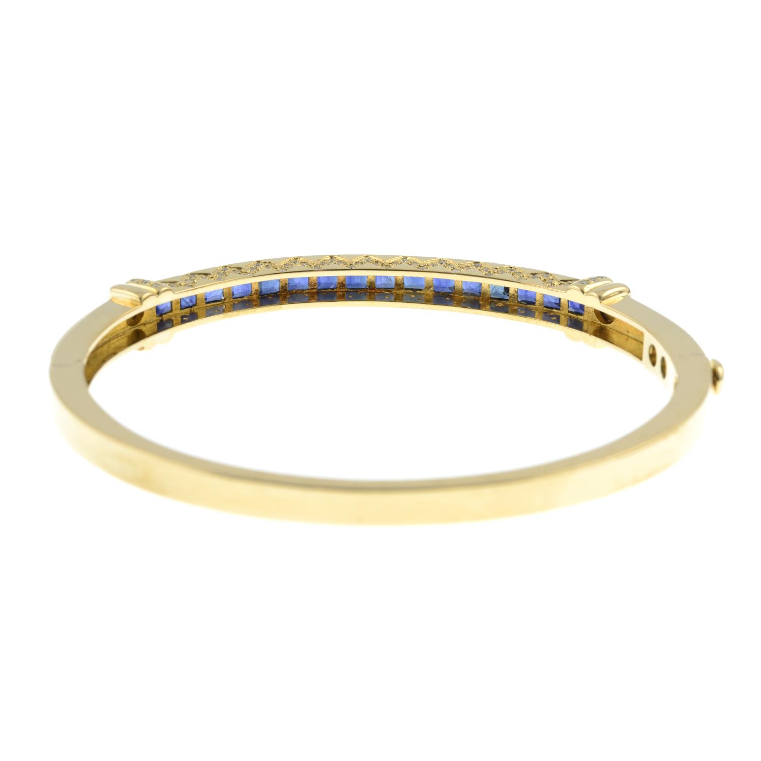 A sapphire and brilliant-cut diamond hinged bangle.Estimated total diamond weight 0.20ct. - Image 3 of 4