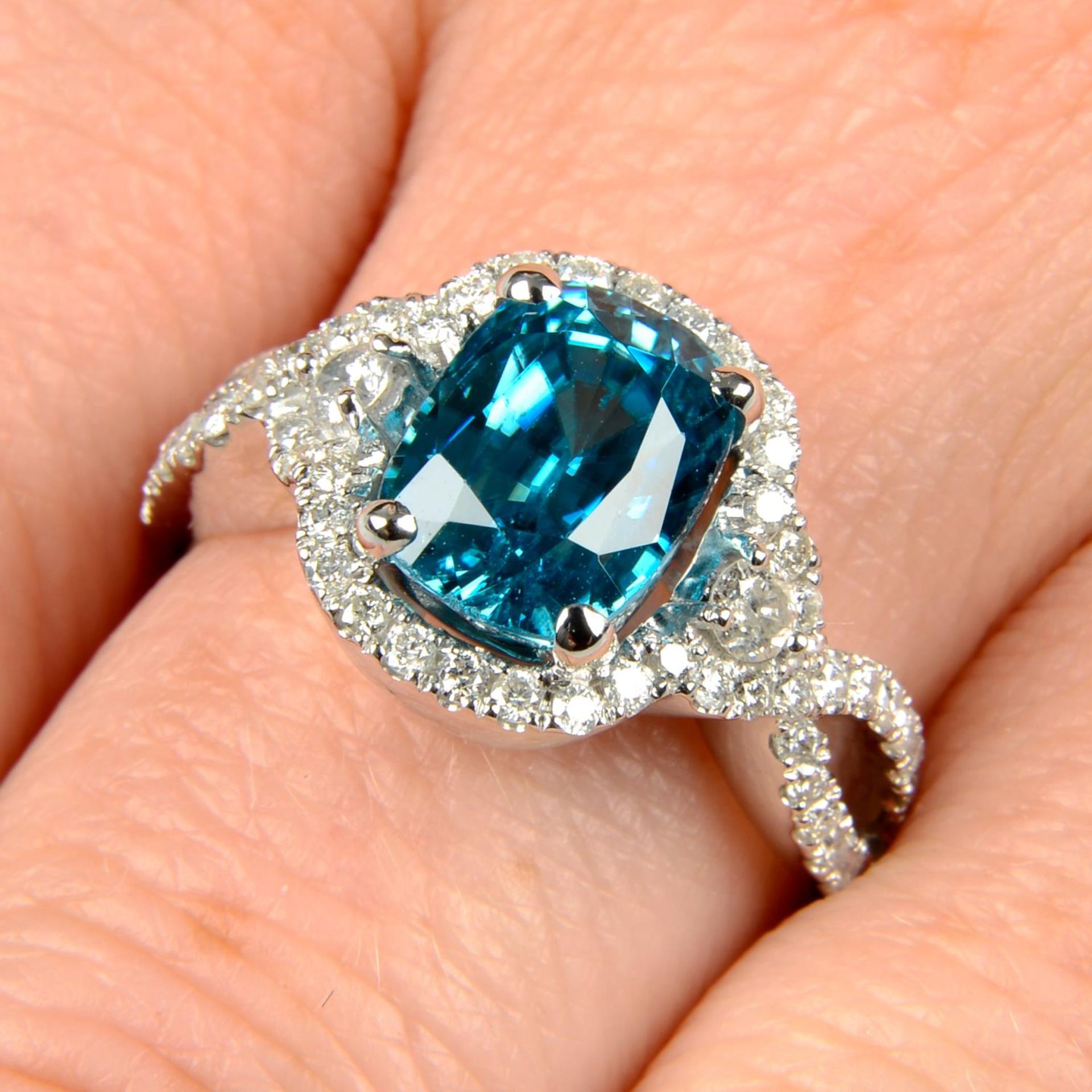 A blue zircon and diamond dress ring.Estimated dimensions of zircon 9 by 6.9 by 6mms.