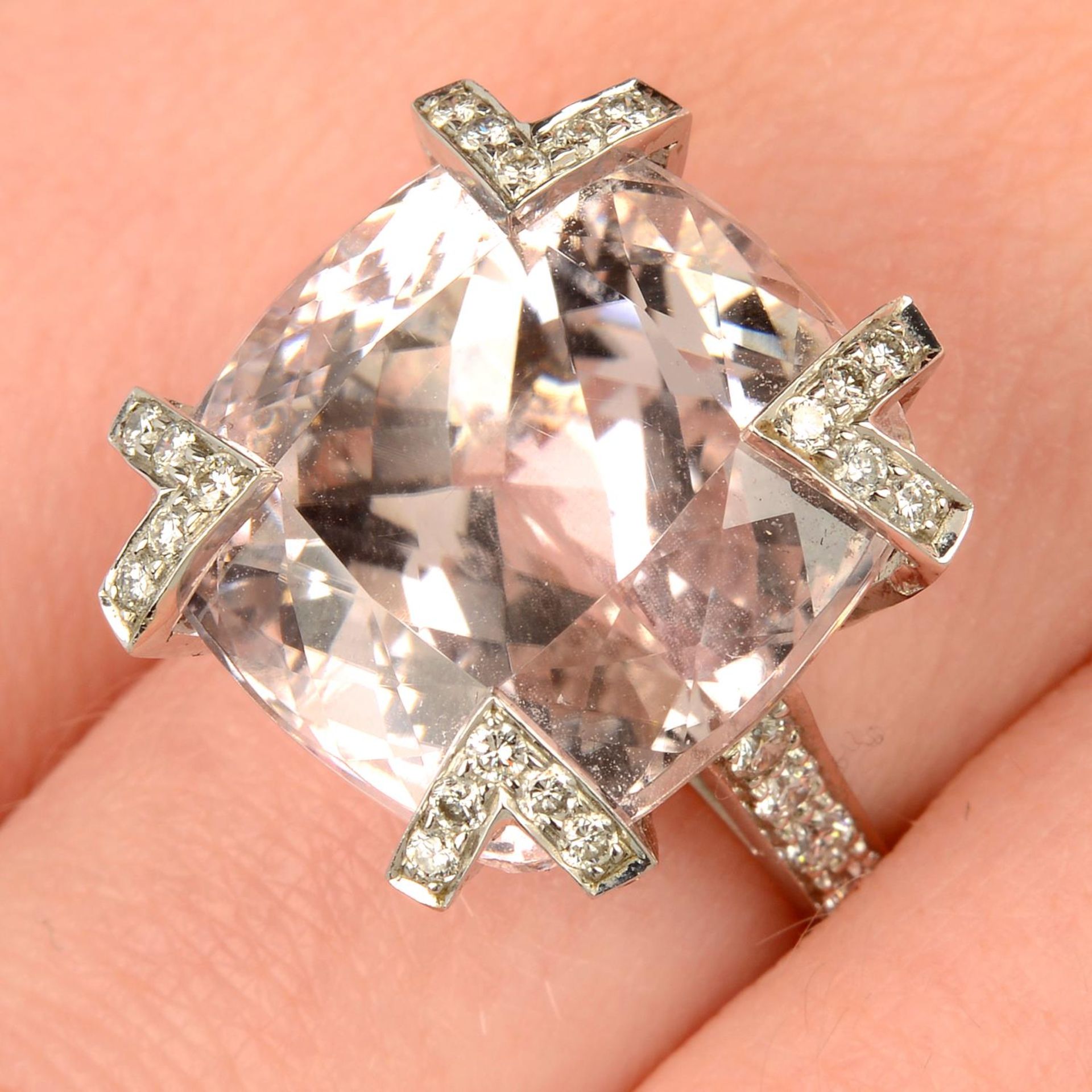 A kunzite dress ring, with pavé-set diamond claws and shoulders.