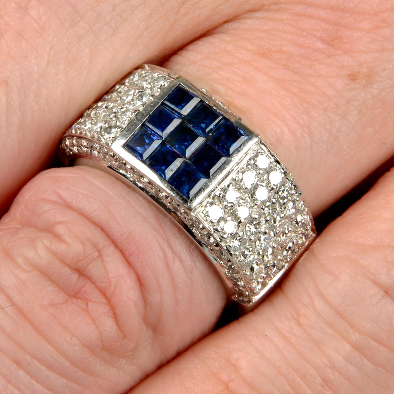 A calibré-cut sapphire and pavé-set diamond band ring.Estimated total diamond weight 1.25cts,