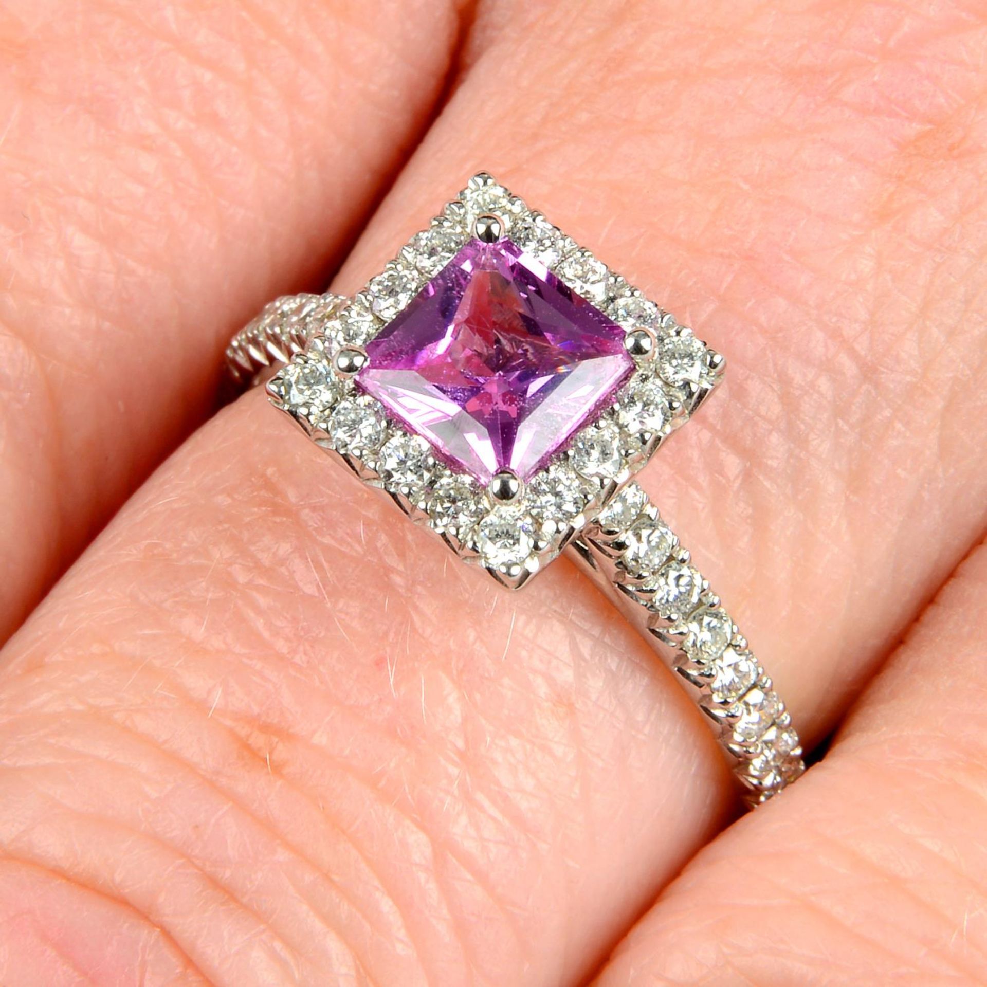 A pink sapphire and diamond square-shape cluster ring.