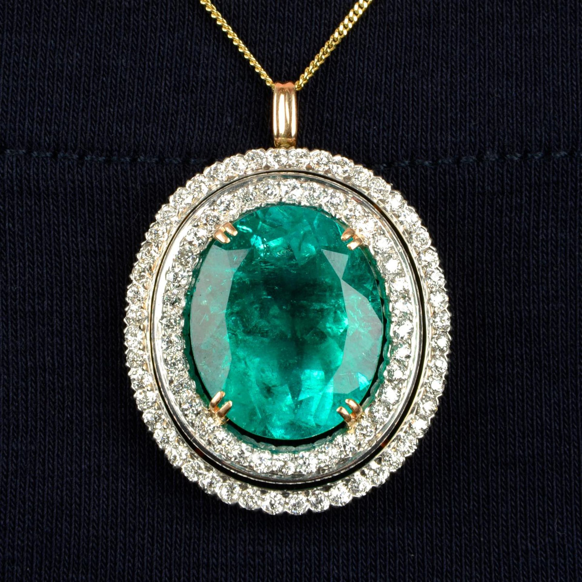 An emerald and circular-cut diamond pendant.With report 17203,