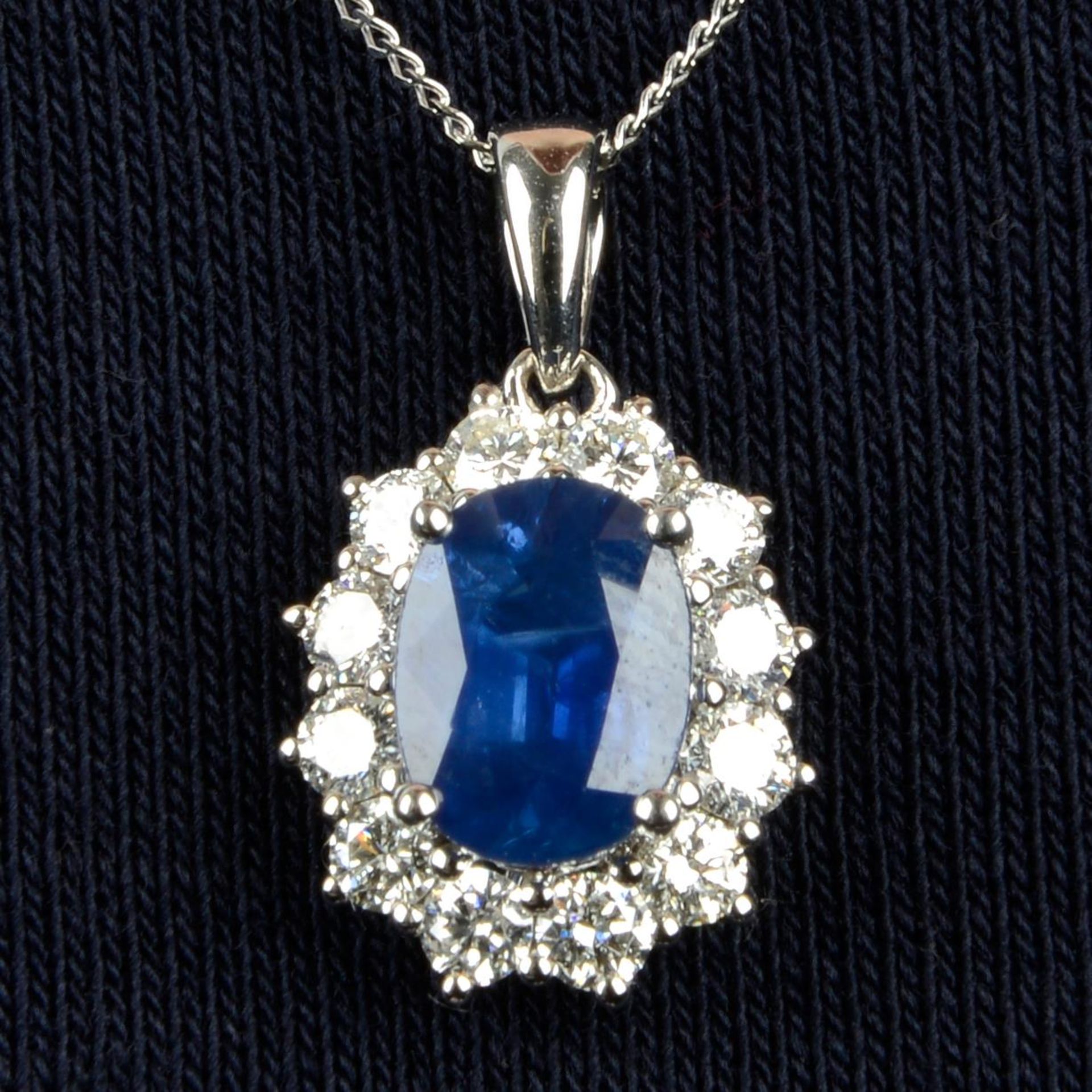 An 18ct gold sapphire and brilliant-cut diamond cluster pendant,