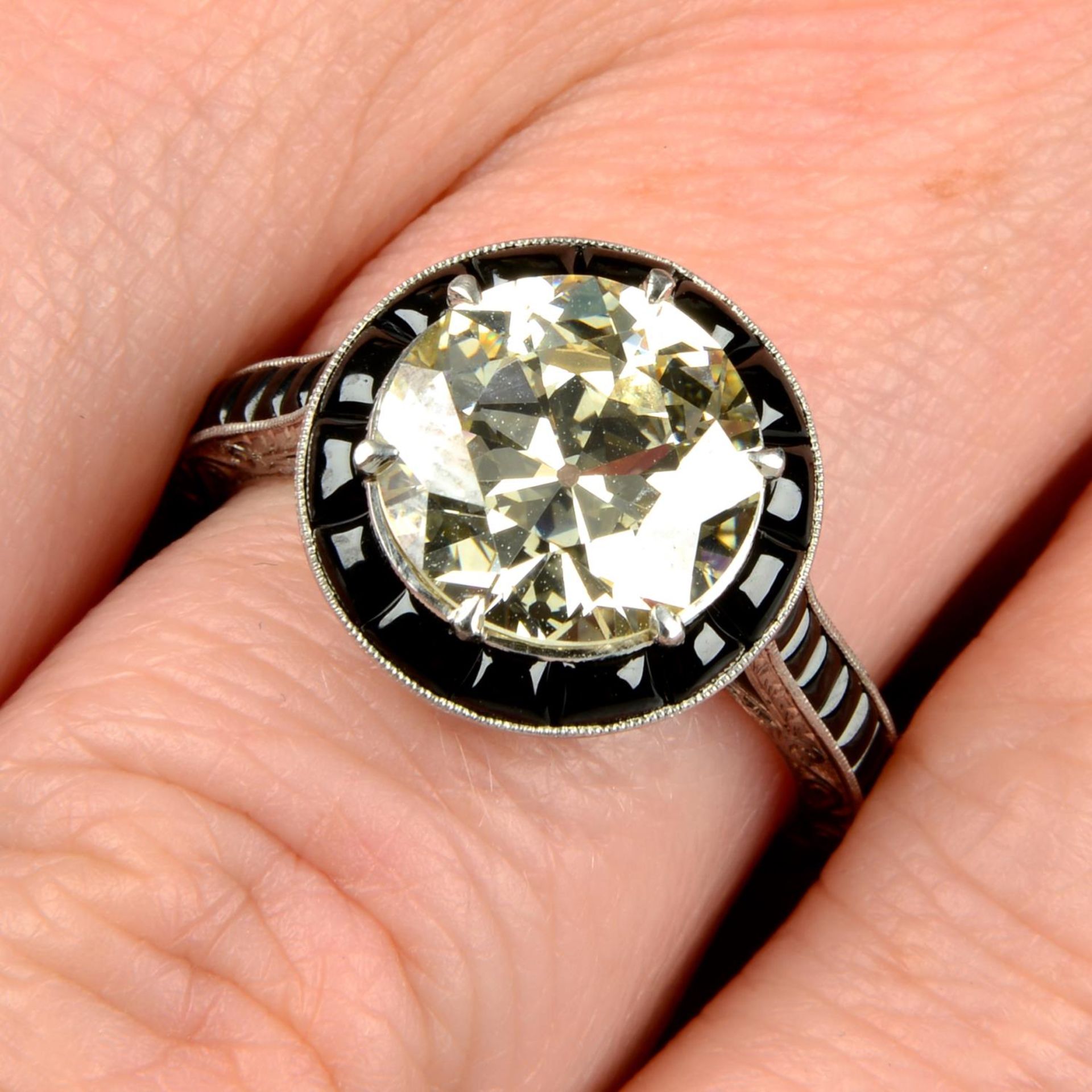 An old-cut diamond dress ring, with onyx surround and shoulders.