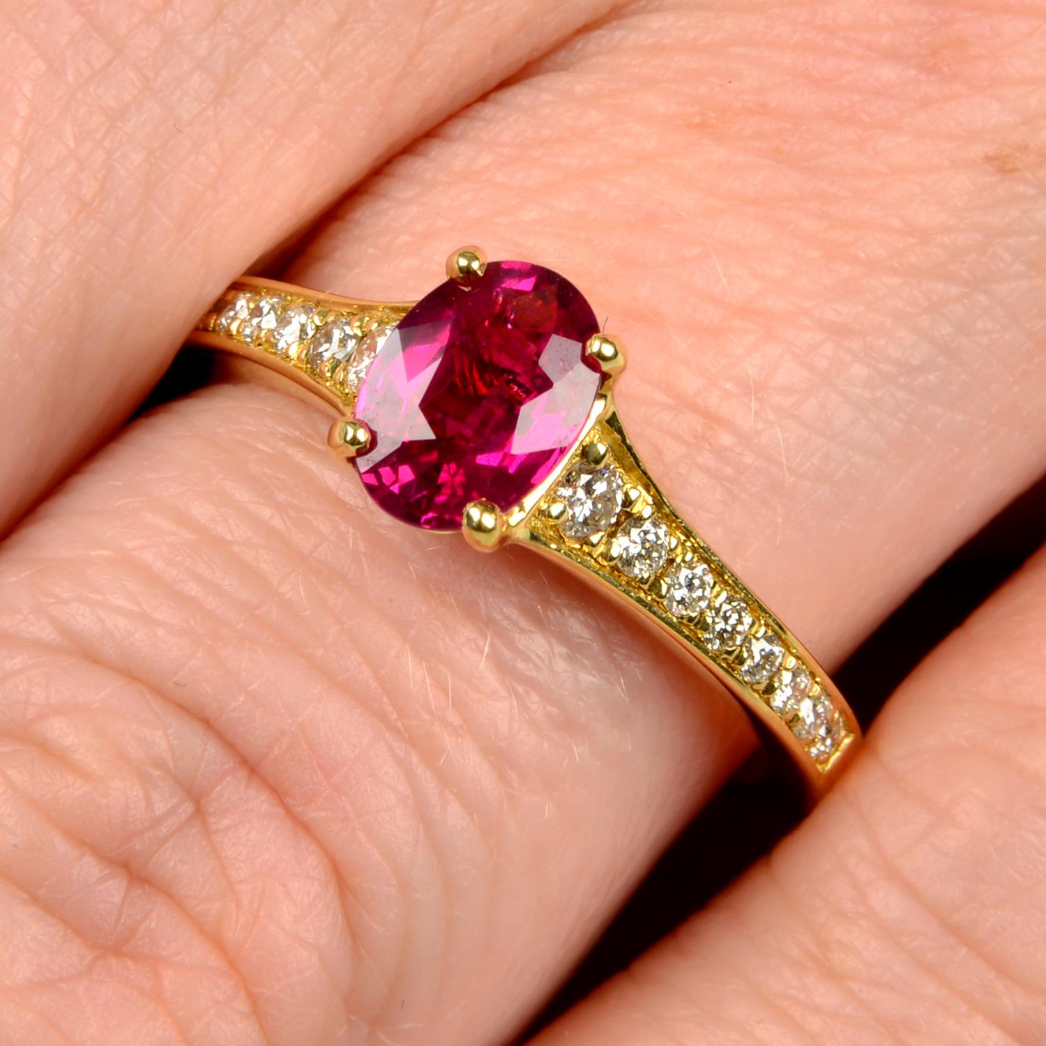 An 18ct gold ruby single-stone ring, with diamond shoulders.