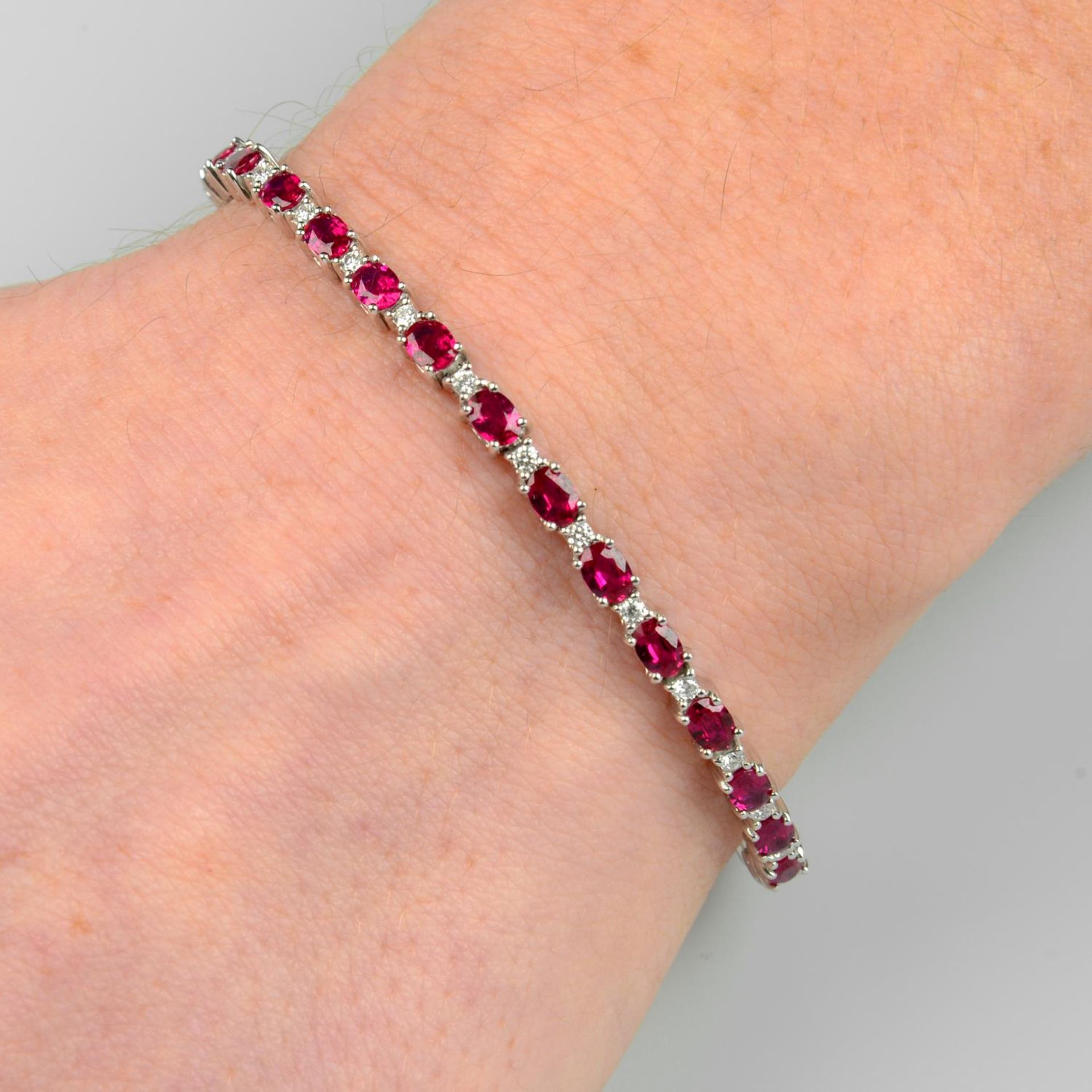 An 18ct gold ruby and diamond line bracelet.