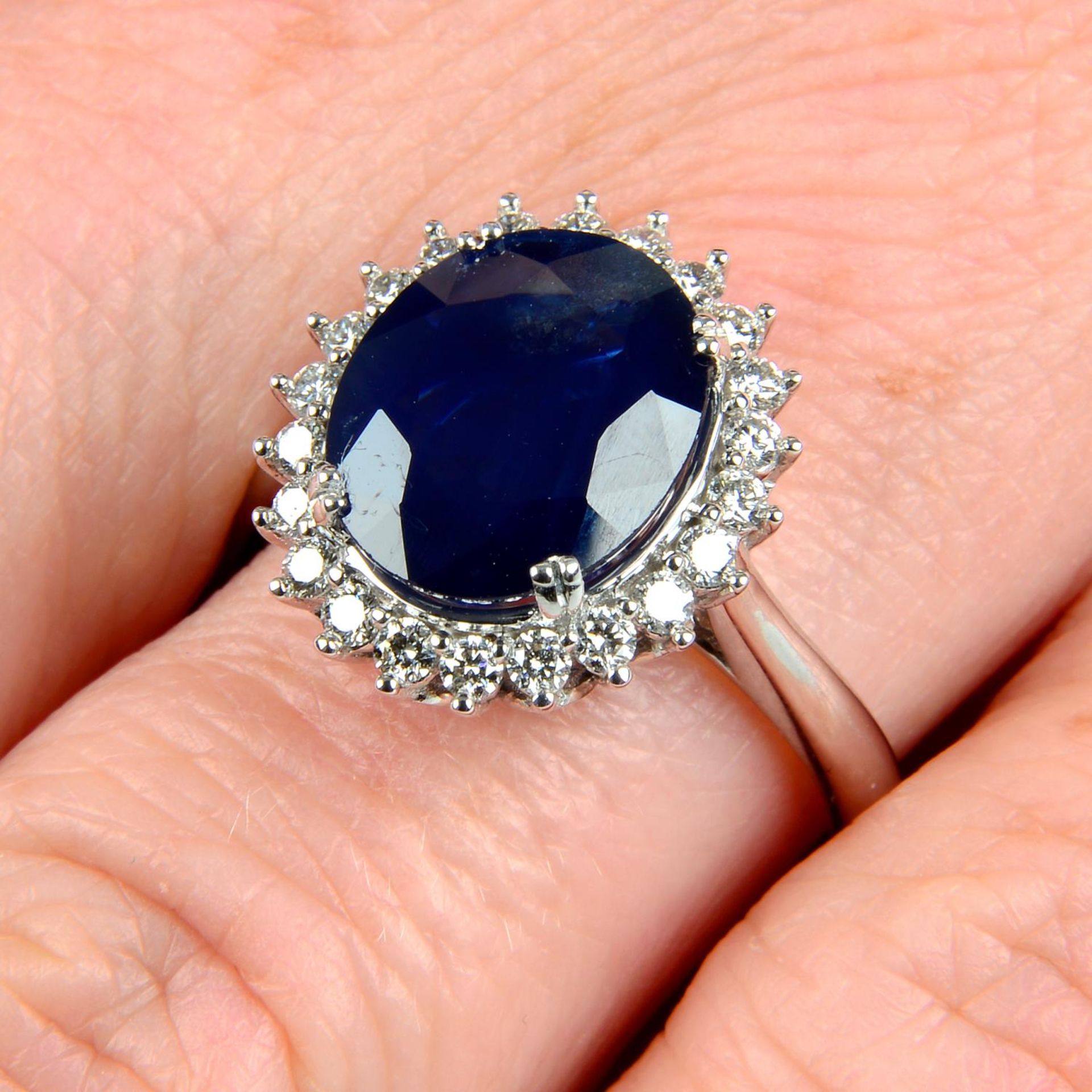 A sapphire and brilliant-cut diamond cluster ring.