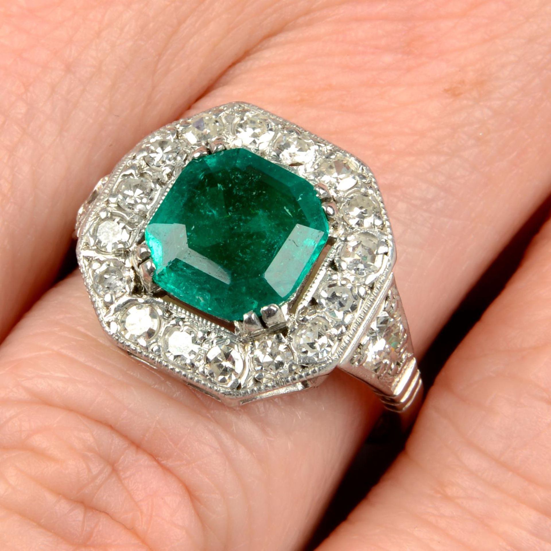 A Colombian emerald and diamond dress ring.