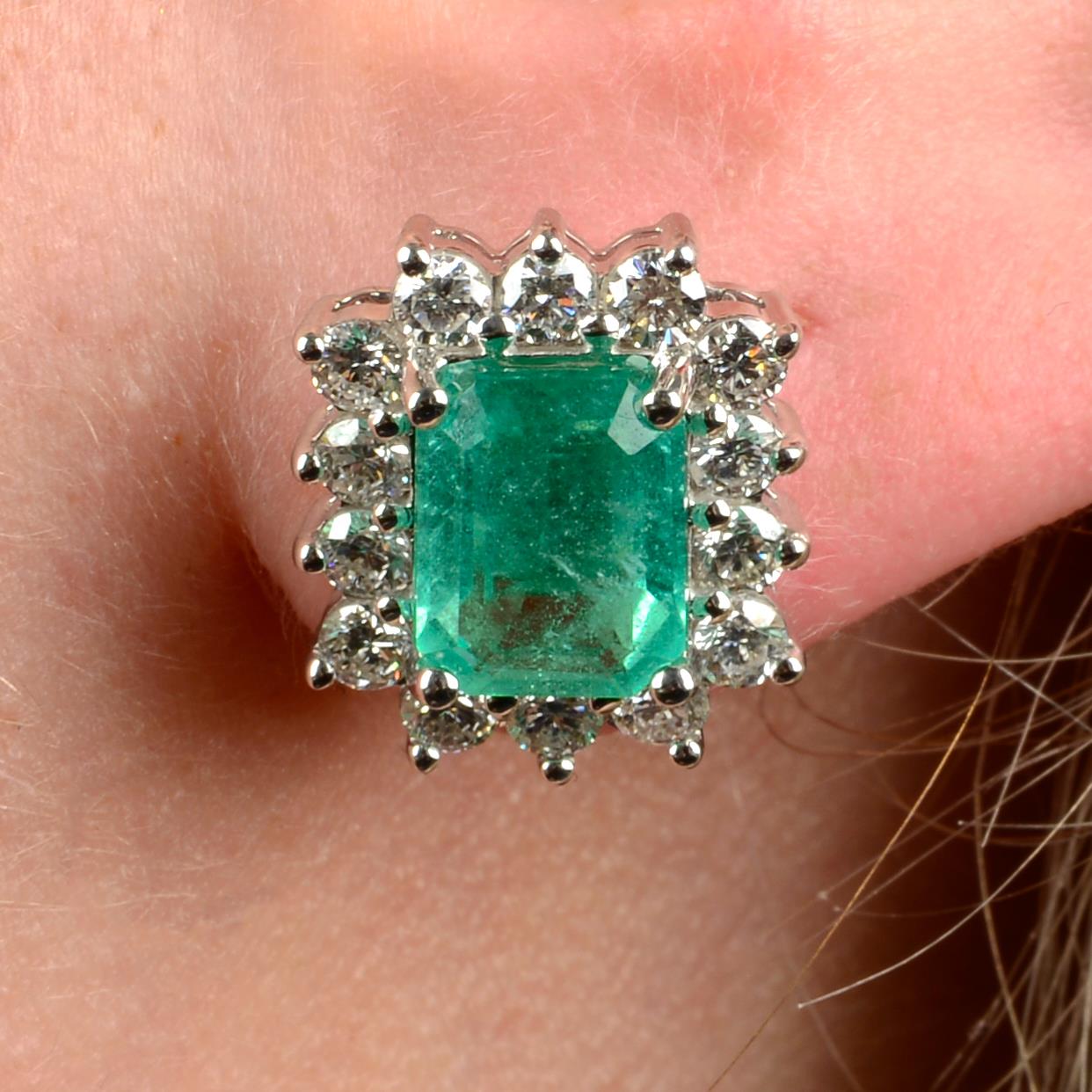 A pair of emerald and diamond cluster earrings.Emerald calculated total weight 3.16cts,