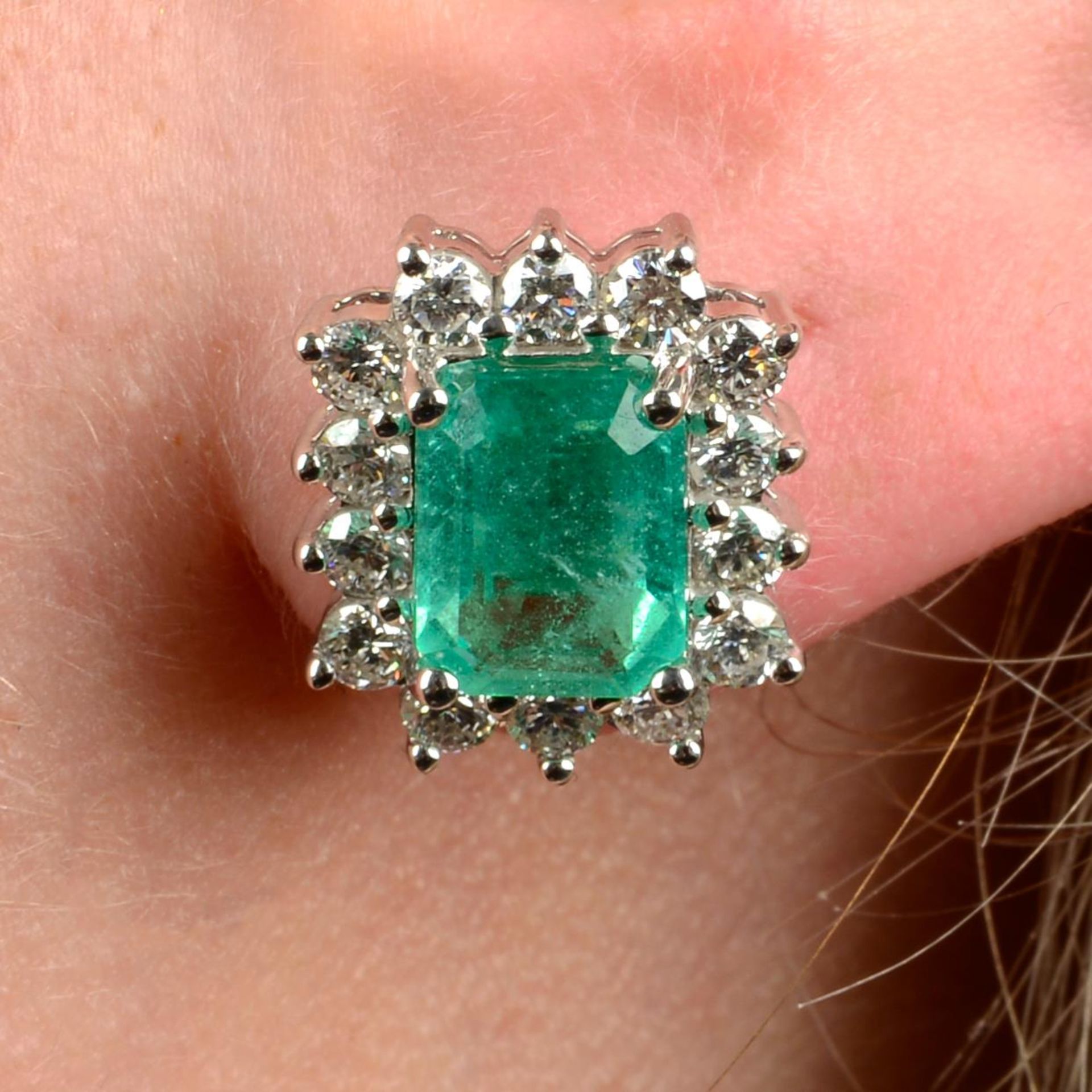 A pair of emerald and diamond cluster earrings.Emerald calculated total weight 3.16cts,