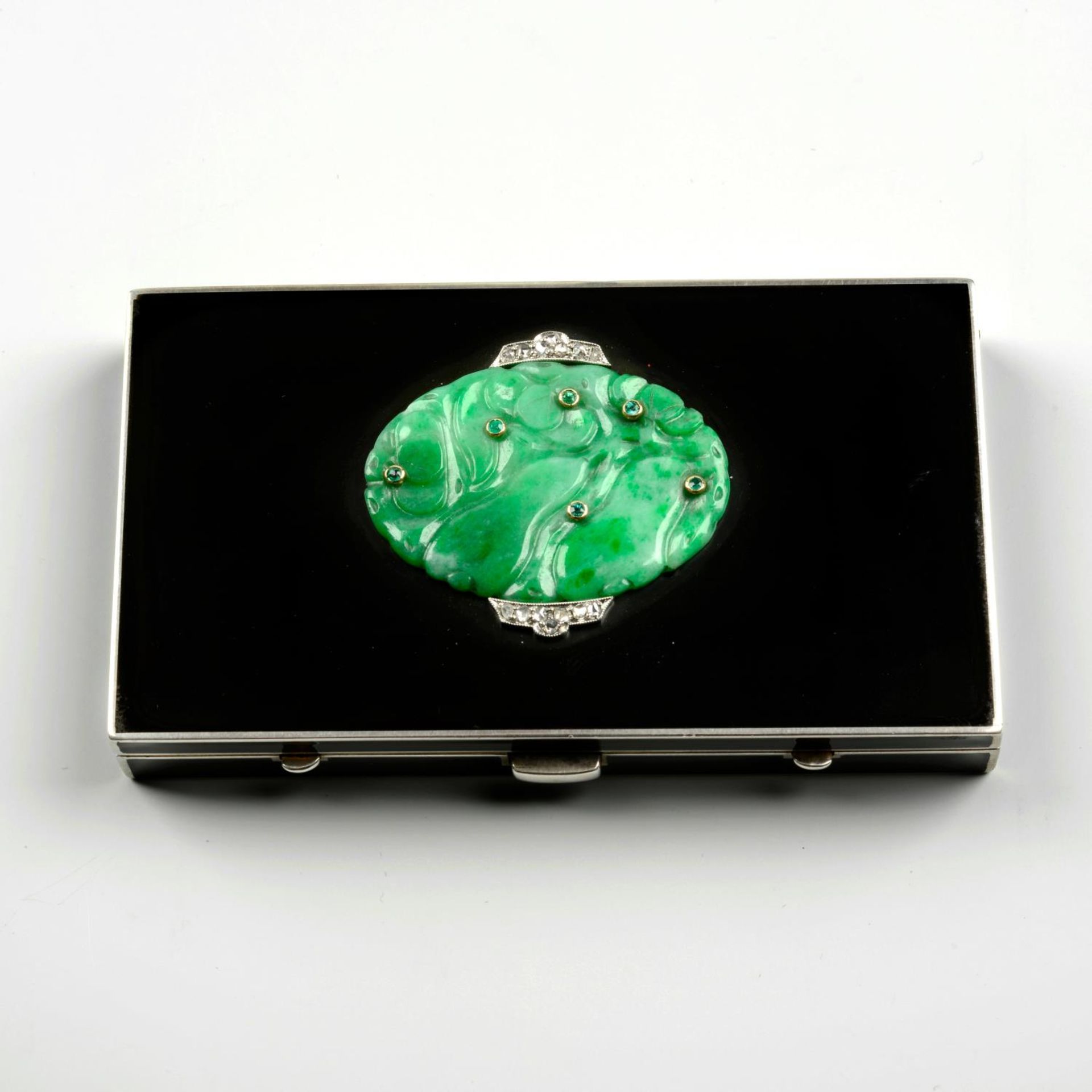 An Art Deco silver, carved jade, emerald, diamond and black enamel vanity case, by Strauss, Allard a