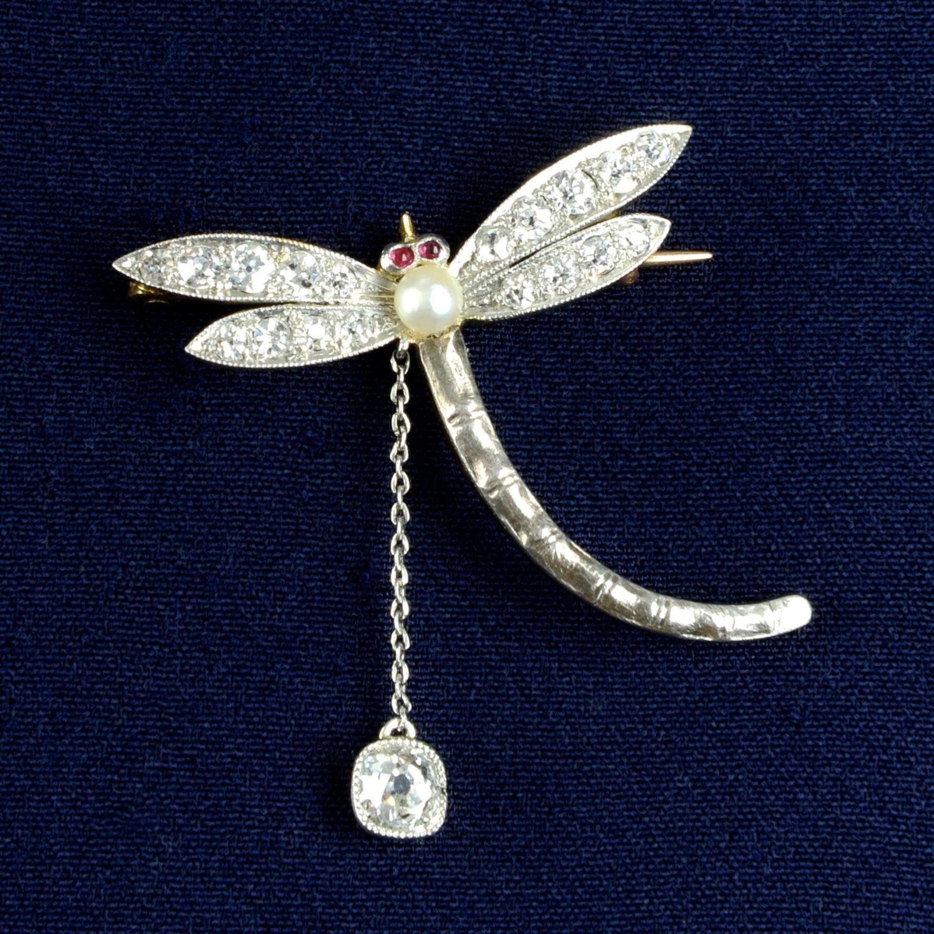 An early 20th century silver and gold, seed pearl, ruby and old-cut diamond dragonfly brooch.