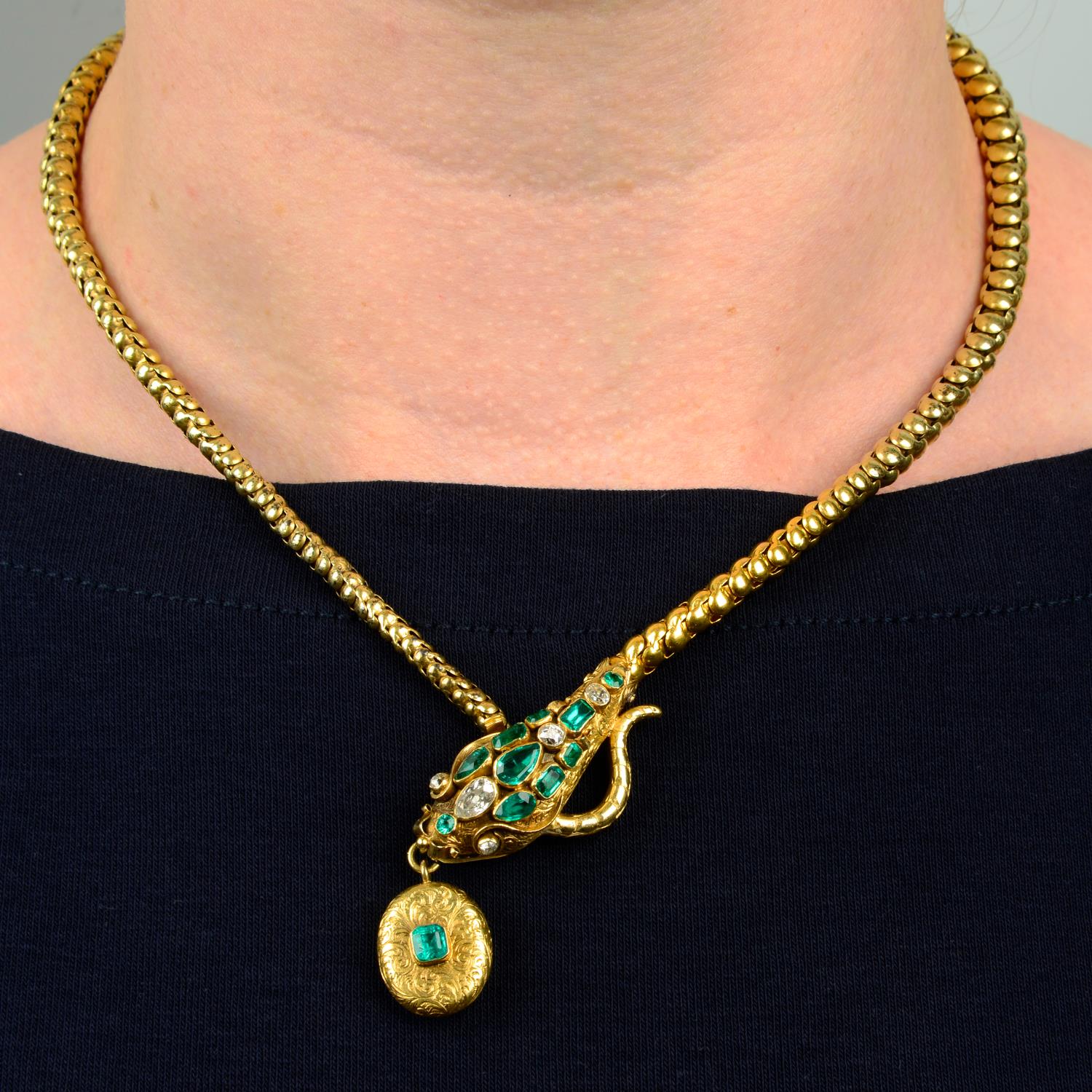 A mid 19th century gold emerald and diamond snake necklace.Estimated total diamond weight 0.50ct,