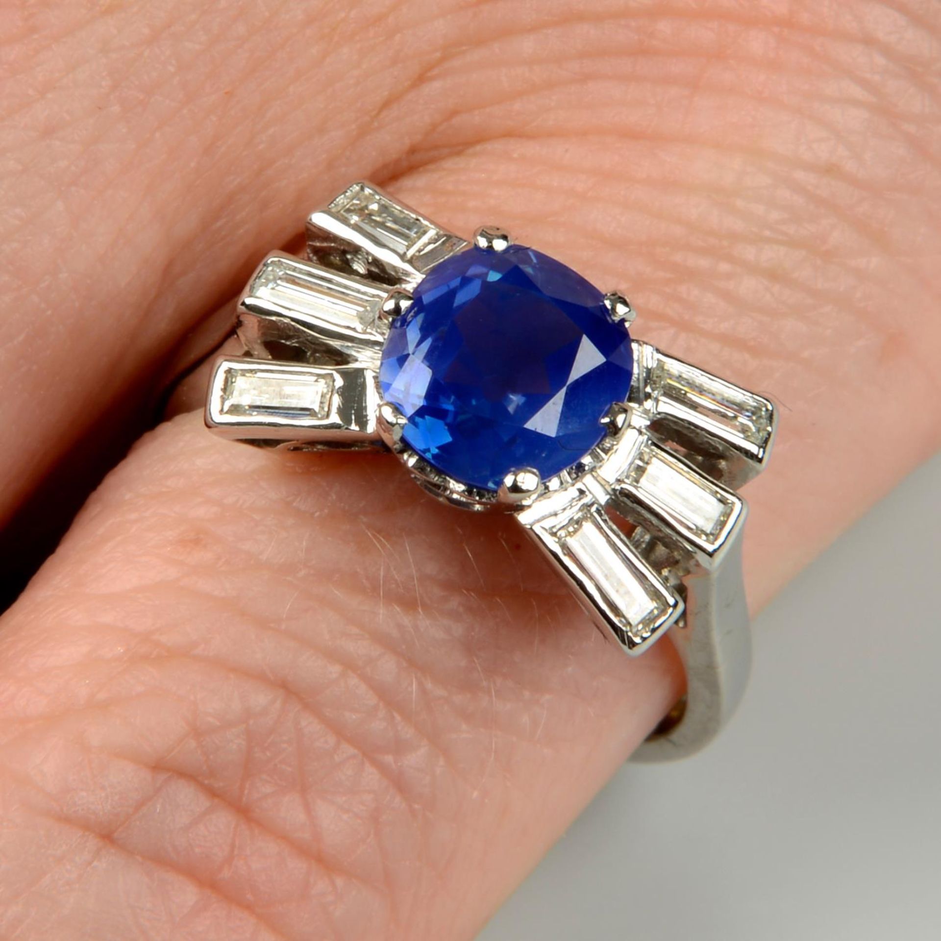 A mid 20th century platinum, Kashmir sapphire and baguette-cut diamond ring.