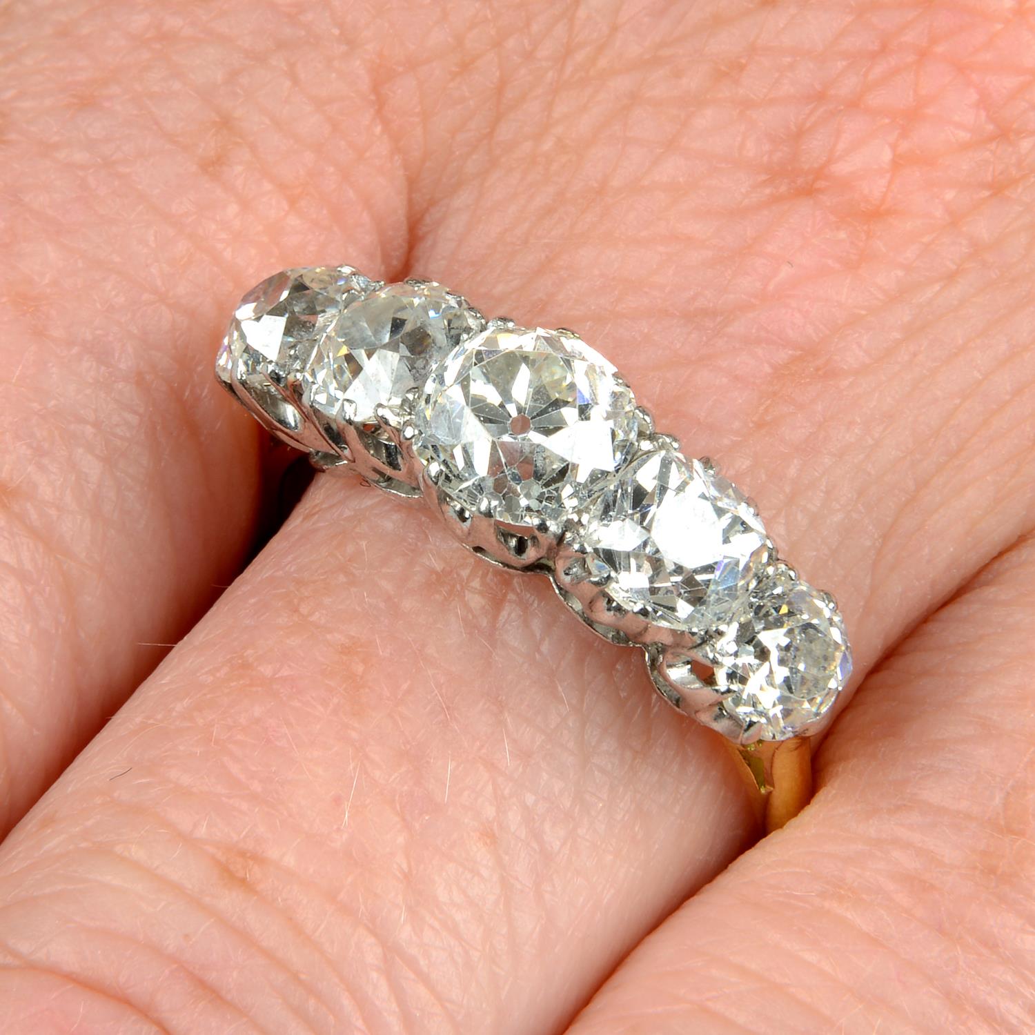 An 18ct gold graduated old-cut diamond five-stone ring.Estimated total diamond weight 4cts,