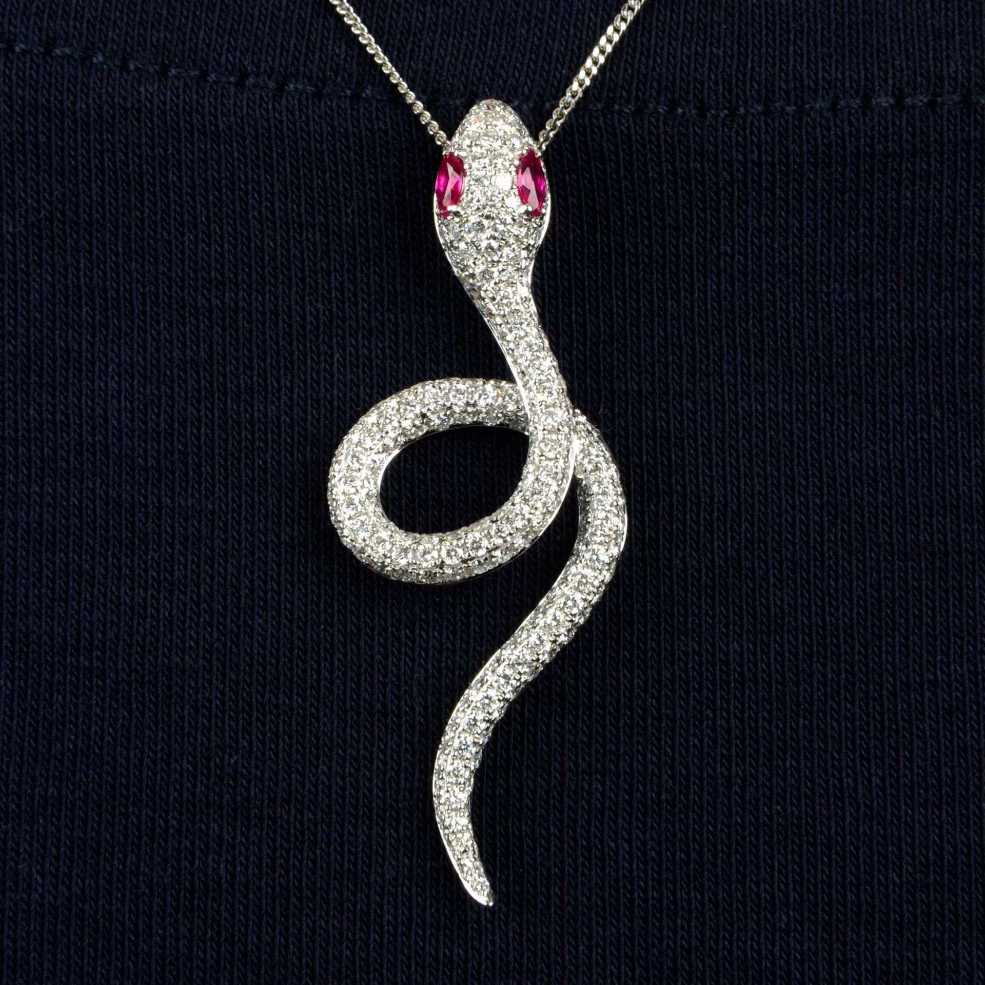 A pavé-set diamond snake pendant,