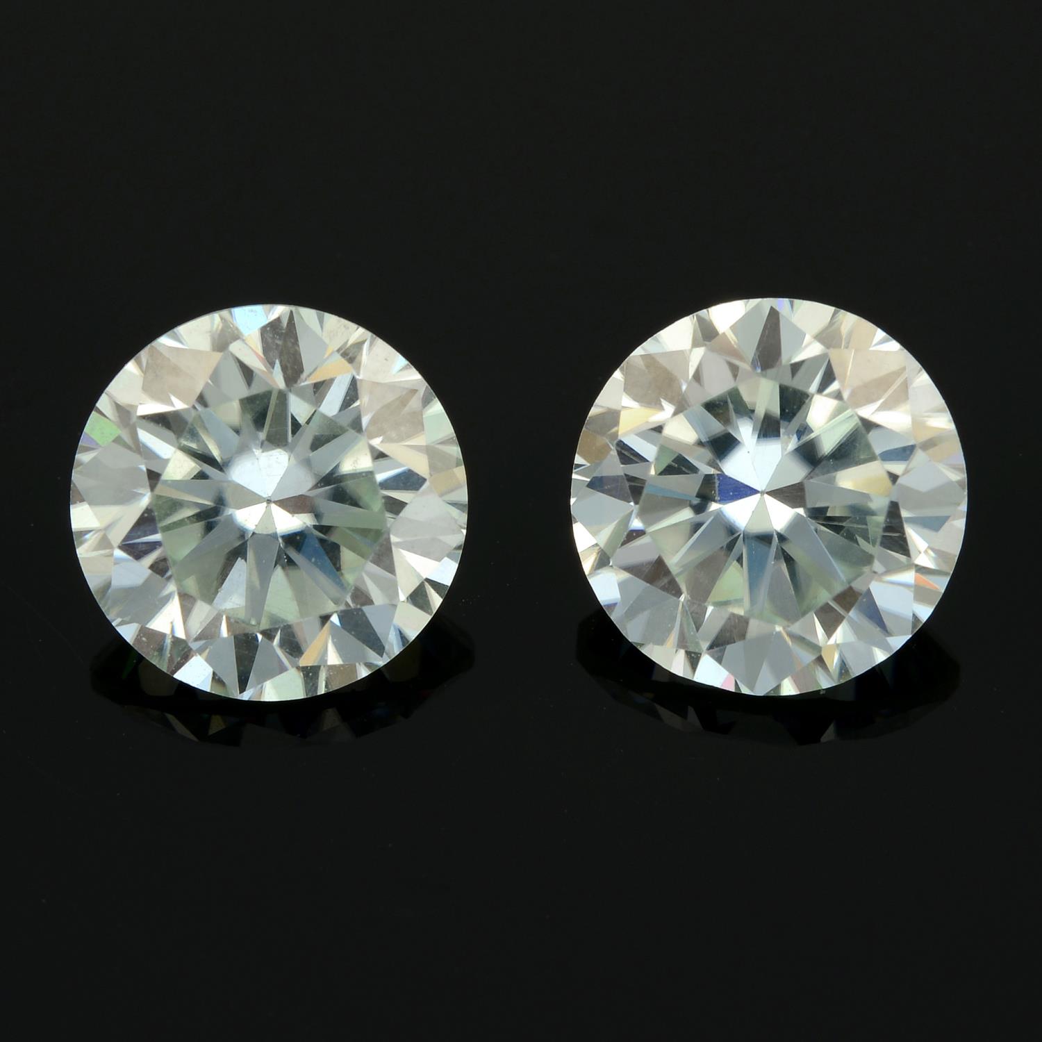 A pair of circular-shape colourless synthetic moissanite total weight 3.76cts.