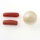 A cultured pearl and two oblong shape coral.