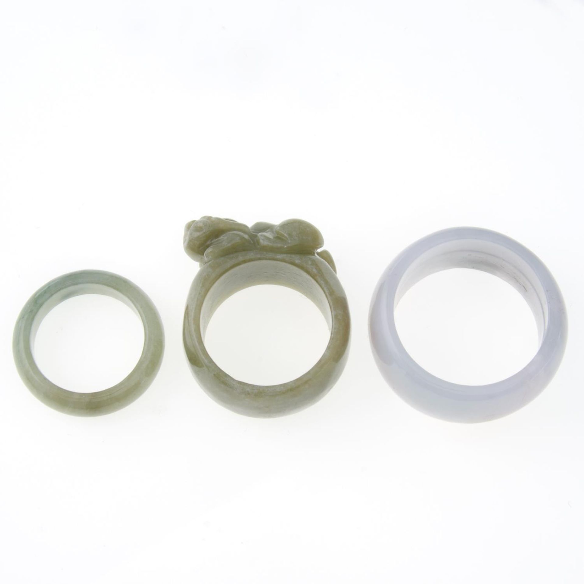 Two jade bangles and three jade rings,