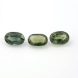 A selection of oval-shape, predominantly green sapphires.