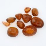 A selection of garnets and topaz, weighing 143cts.