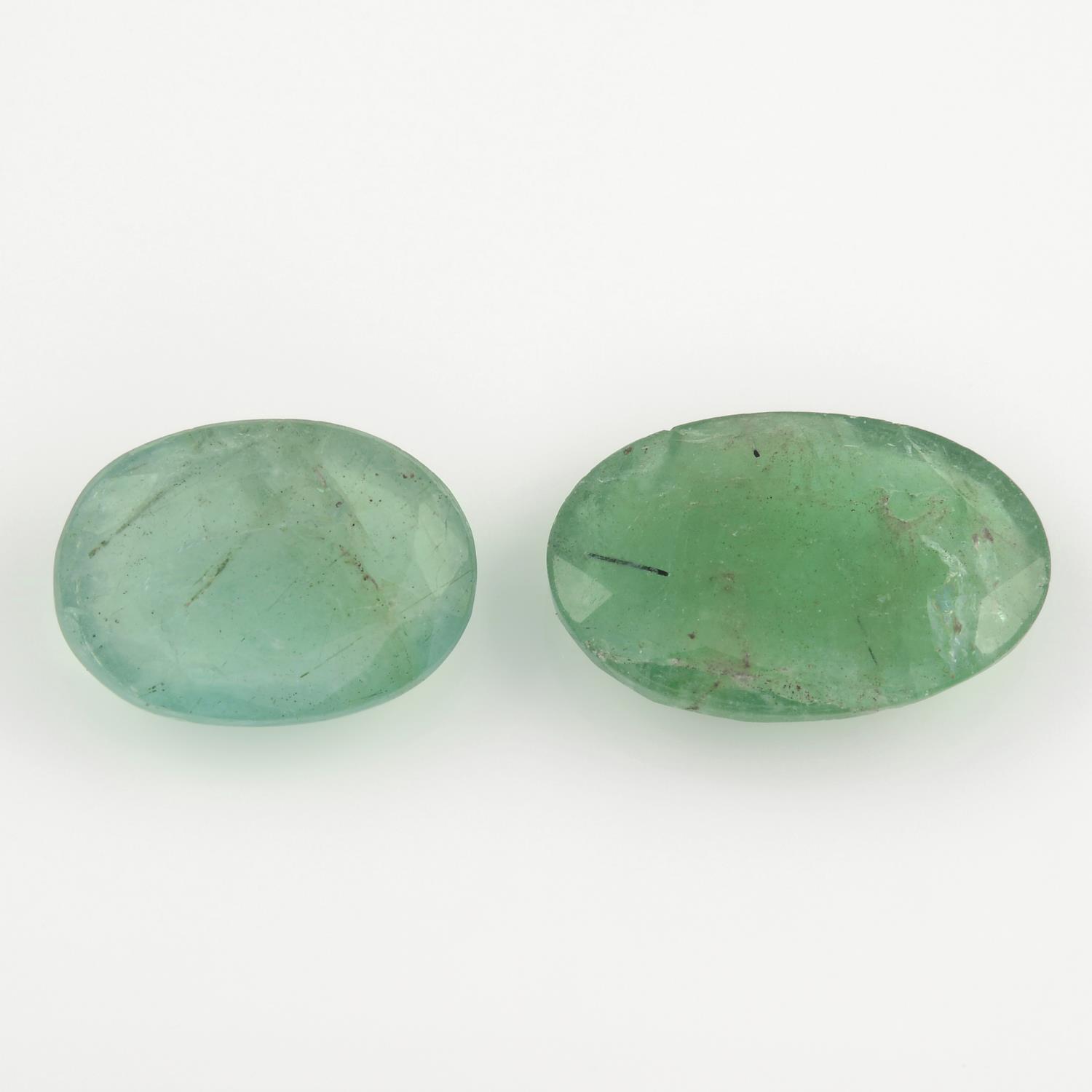 Two oval shape emeralds, weighing 8.58ct.