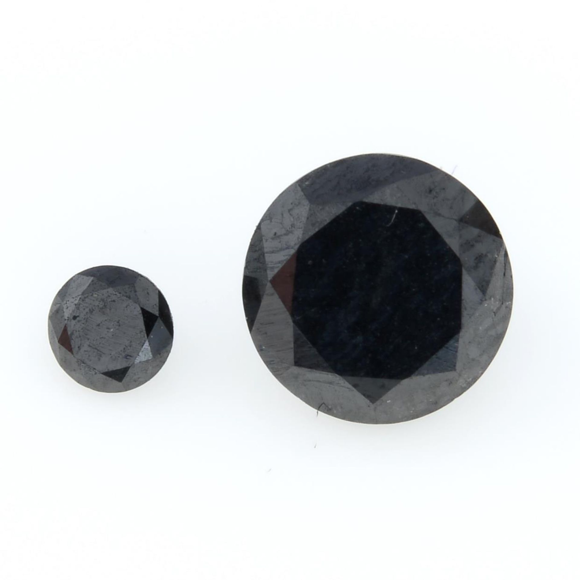 Two black gemstones, weighing 1.23ct.