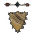 Three Scottish agate brooches and an Irish serpentine brooch and a silver olive fork.Three with