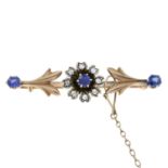 A diamond and sapphire floral brooch.Length 4.5cms.