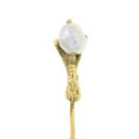 A late Victorian gold baroque pearl eagle claw stickpin.