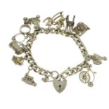 A silver charm bracelet and assorted charms.Hallmarks for Birmingham, 1976.Length 19.3cms.