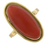 A coral single-stone ring.Stamped 750.Ring size O 1/2.