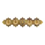 A early 20th century 15ct gold brooch, depicting five horseshoes.Stamped 15ct.Length 3.7cms.