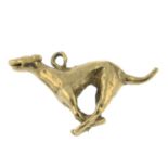 A 9ct gold charm pendant of a sprinting greyhound.Hallmarks for London.Length 2.5cms.