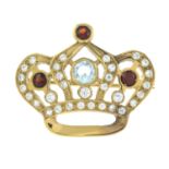 A garnet, topaz and cubic zirconia brooch of a crown.Length 3.2cms.