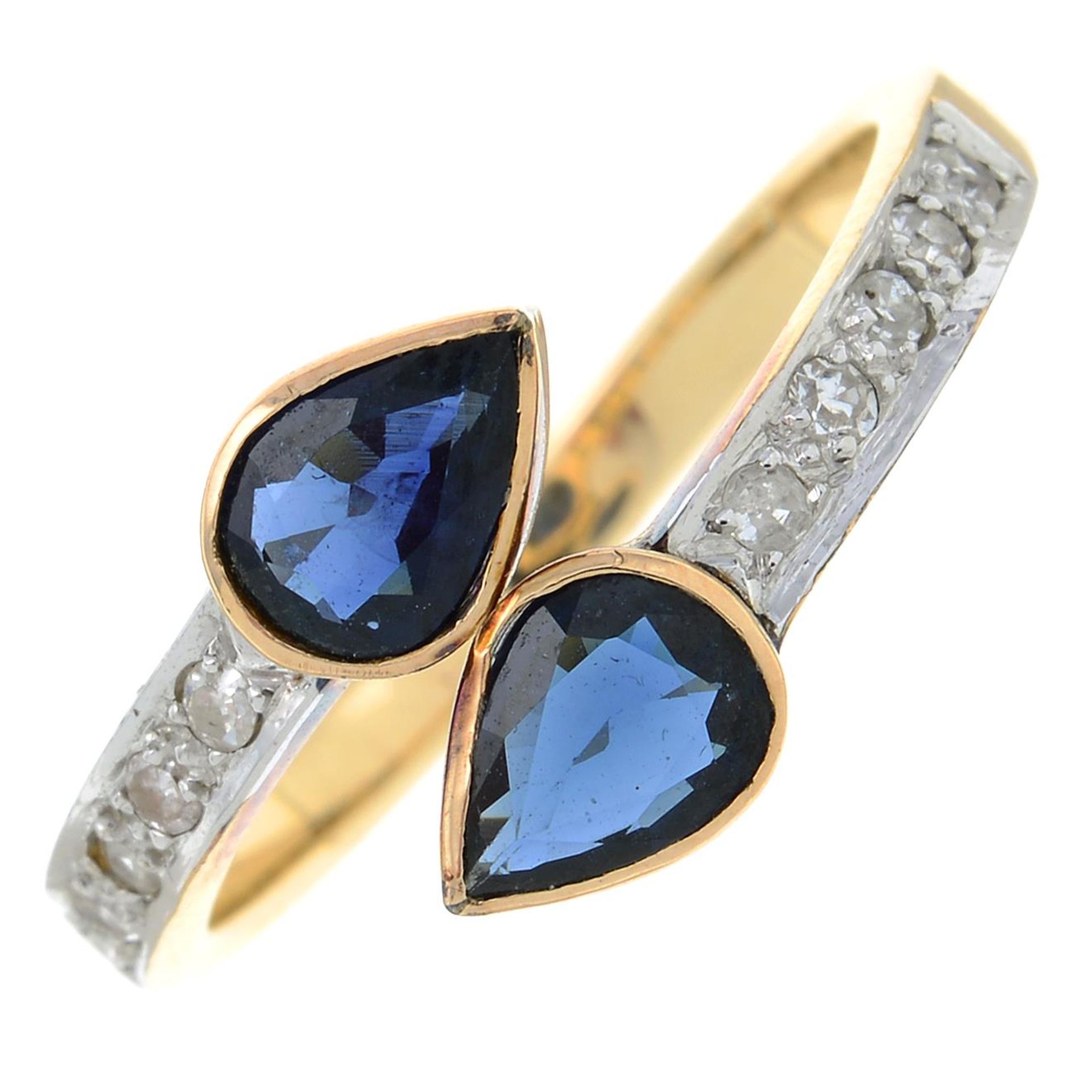 A diamond and sapphire dress ring.Estimated total diamond weight 0.10ct.Stamped 585.Ring size M1/2.