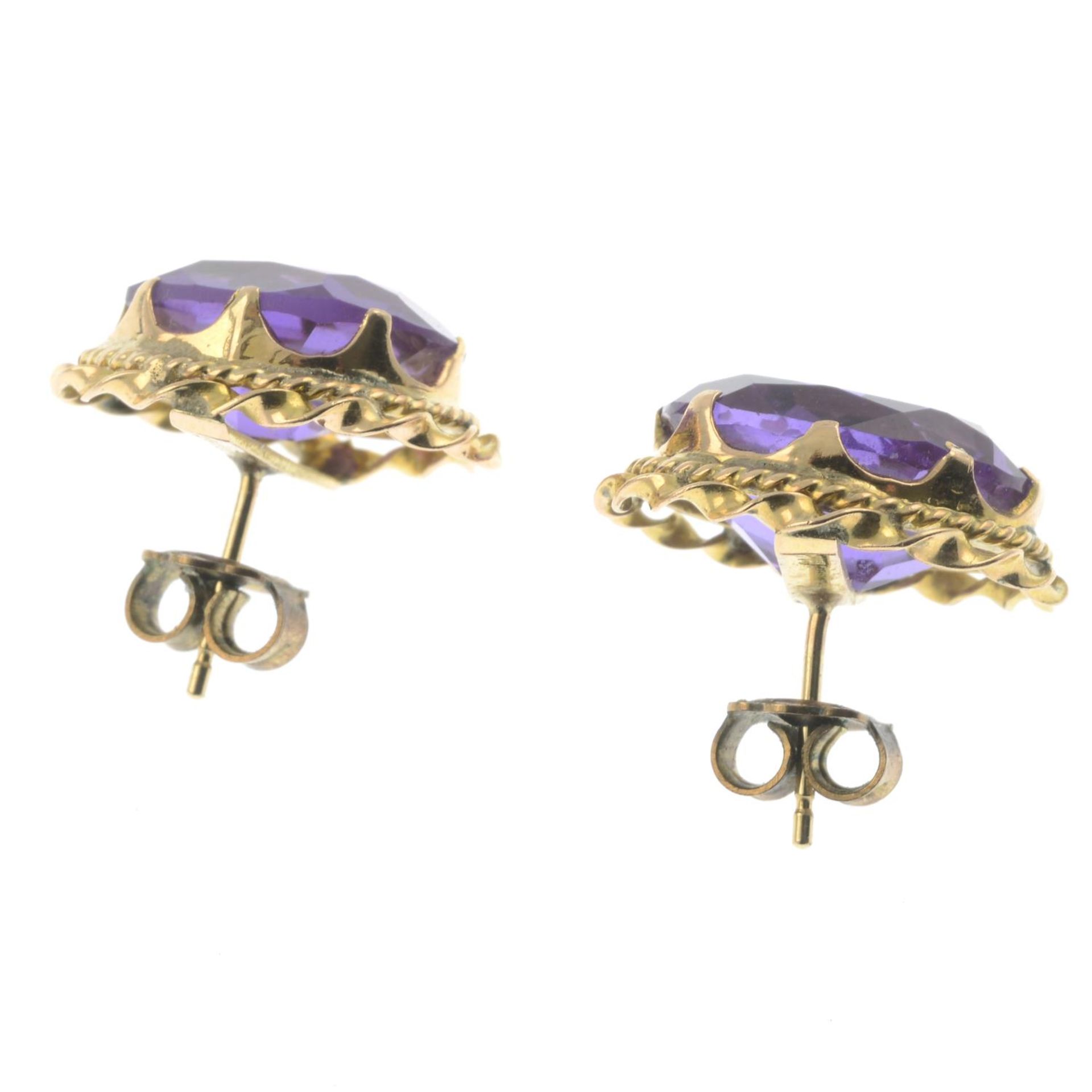 A pair of synthetic colour-change sapphire earrings.Marks to indicate gold, partially indistinct. - Image 2 of 2