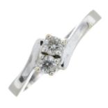 A diamond two-stone ring.Estimated total diamond weight 0.20cts,