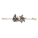 A 9ct old-cut diamond and ruby butterfly bar brooch.Length 5.3cms.