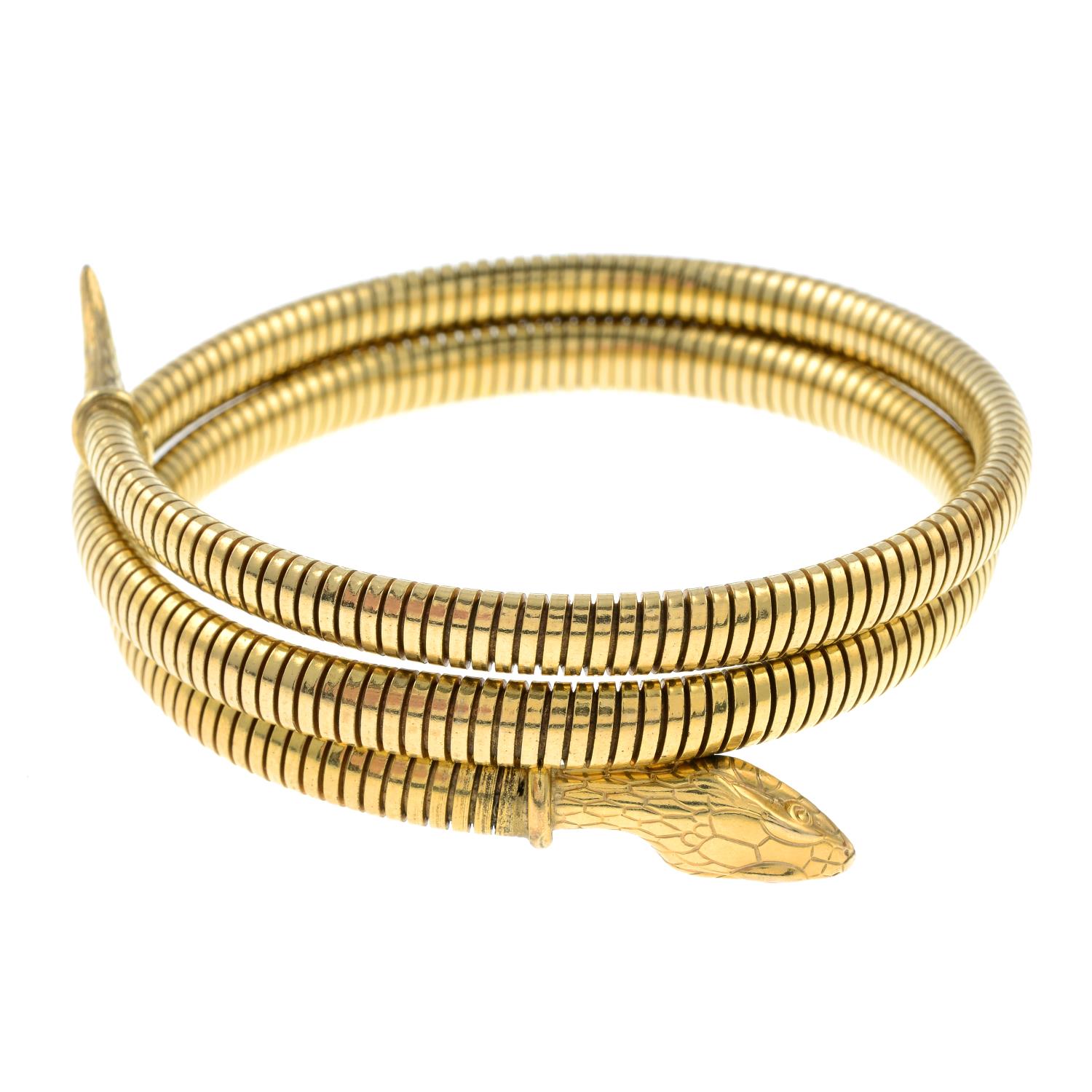 A mid 20th century rolled gold engraved snake bangle.Stamped rolled gold.