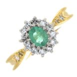 An 18ct gold emerald and diamond cluster ring.Estimated total diamond weight 0.15ct.Hallmarks for