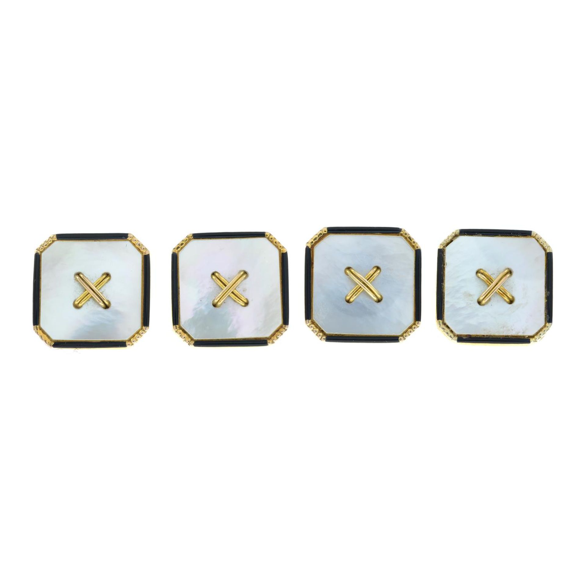 A set of four 9ct gold mother-of-pearl and enamel buttons.Stamped 9ct.Length 1cms.