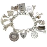 A silver curb-link charm bracelet, with a selection of assorted charms.