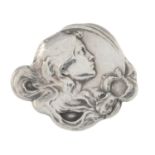 An Art Nouveau brooch of a lady's profile.Stamped silver.Length 2.8cms.