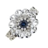 A diamond and sapphire cluster ring of floral design.Estimated total diamond weight 0.16cts.Stamped